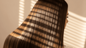 Cabelo castanho com brilho espelhado e reflexos de luz após banho de brilho caseiro.